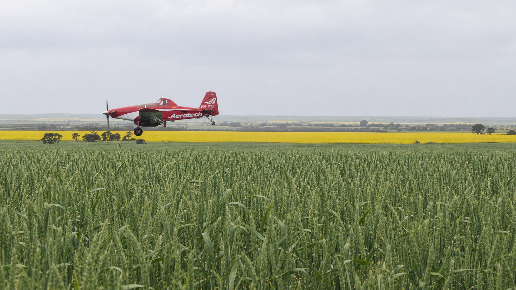 Aerotech agricultural aircraft flying over a crop